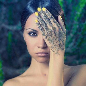 Beautiful young lady with painted hands mehendi